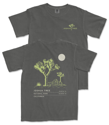 a gray t-shirt with a graphic design depicting a tree and a moon. The t-shirt has text on the back that reads "JOSUA TREE 33.734 N. CA. 1019 W."