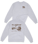 A gray sweatshirt with a bear and a landscape printed on the back.
