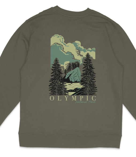 A graphic t-shirt with a nature-inspired design featuring a mountain landscape with pine trees and a body of water.