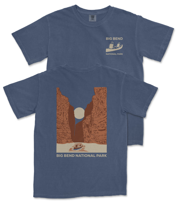 A blue t-shirt with a graphic design depicting a canyon landscape and a boat on a river, along with the text "BIG BEND NATIONAL PARK".