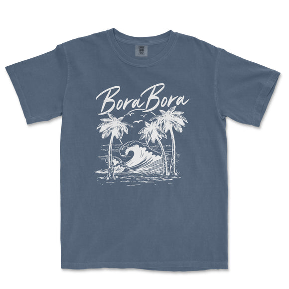 a blue t - shirt with a picture of a wave and palm trees