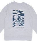 A gray sweatshirt with a graphic design depicting a mountain landscape with a bear on a rock.
