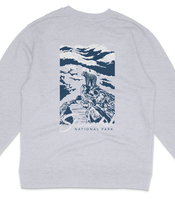 A gray sweatshirt with a graphic design depicting a mountain landscape with a bear on a rock.