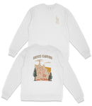 a white long-sleeved shirt with a graphic design depicting a scenic landscape with a mountain range and trees.