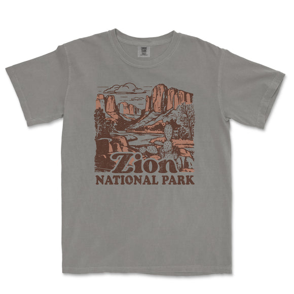 a gray t - shirt with a picture of a mountain scene