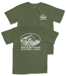 A green t-shirt with white text and graphics printed on it, depicting a mountain landscape.