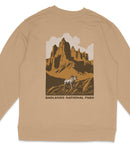 a graphic design of a mountain landscape with a goat in the foreground, and the text "BADLANDS NATIONAL PARK" below the image.