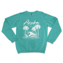 an aqua sweatshirt with a white graphic of a wave and palm trees