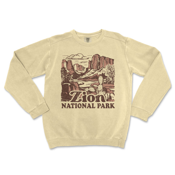 a beige sweatshirt with a picture of a canyon