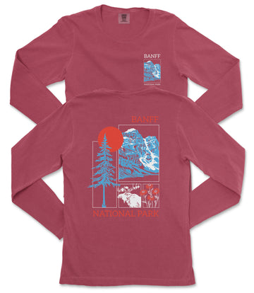 a red long-sleeved t-shirt with a graphic design featuring a tree, mountains, and a sun. The design also includes text that reads "Banff National Park".