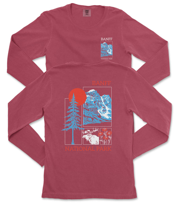 a red long-sleeved t-shirt with a graphic design featuring a tree, mountains, and a sun. The design also includes text that reads "Banff National Park".