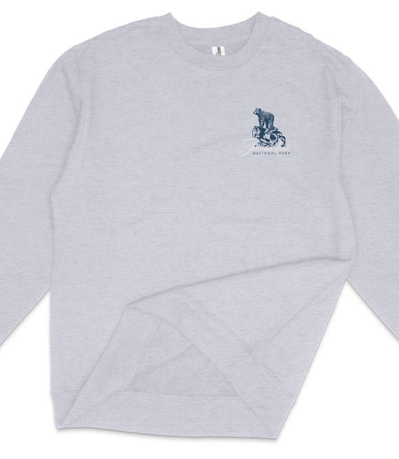 A gray long-sleeved shirt with a small graphic design on the left side.