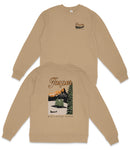 A tan sweatshirt with a graphic design depicting a scenic landscape, including mountains, trees, and a lake. The text on the back of the sweatshirt says "Jasper National Park".