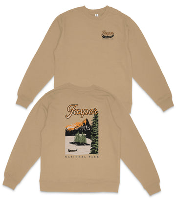 A tan sweatshirt with a graphic design depicting a scenic landscape, including mountains, trees, and a lake. The text on the back of the sweatshirt says "Jasper National Park".