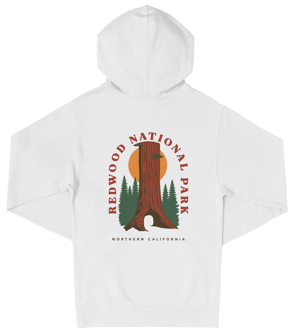 A white hooded sweatshirt with a graphic design featuring a tall tree with a sun in the background, surrounded by pine trees.