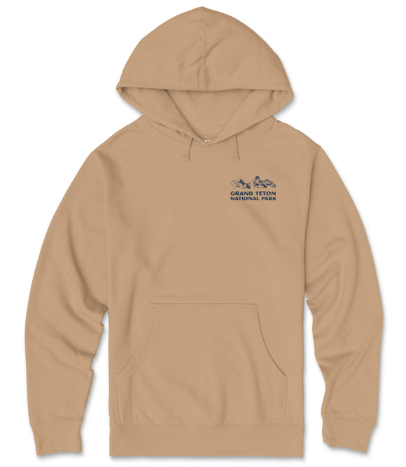 A beige hoodie with a graphic design on the front, featuring a mountain range and the text "GRAND Teton National Park" printed on it.