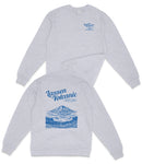 A grey sweatshirt with a graphic design on the back featuring a mountain and text.