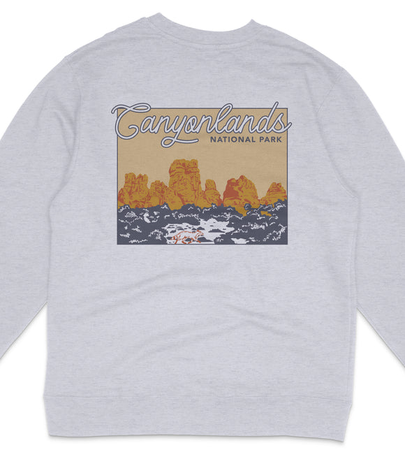 A gray sweatshirt with a graphic design depicting a scenic landscape with mountains and a body of water.