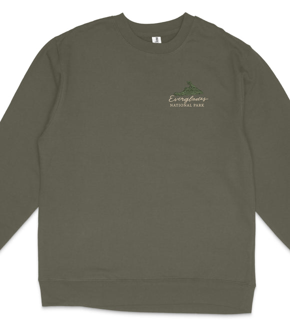 A dark green long-sleeved shirt with a small logo on the left side.