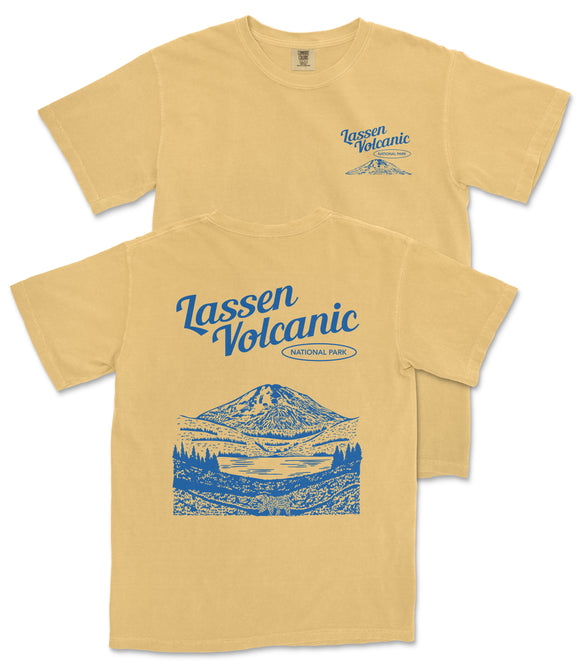 A yellow t-shirt with a graphic design depicting a mountain landscape and the text "Lassen Volcanic National Park" printed on it.