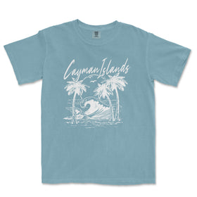 a blue t - shirt with a picture of a surfboarder riding a wave