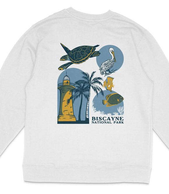 A white sweatshirt with a graphic design featuring various sea creatures and landmarks, including a lighthouse, palm trees, and a bird.