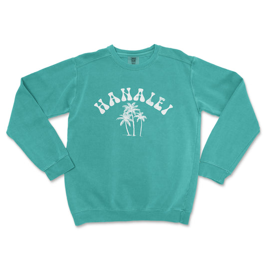 a green sweatshirt with a palm tree and the word hawaii printed on it