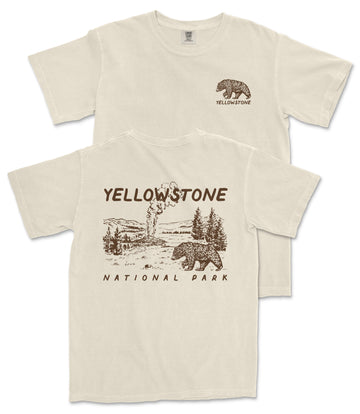 A beige t-shirt with a graphic design depicting a bear and a landscape, along with the text "Yellowstone National Park" printed on it.