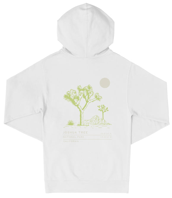 A white hooded sweatshirt with a graphic design depicting a desert landscape with a tree and a small moon.