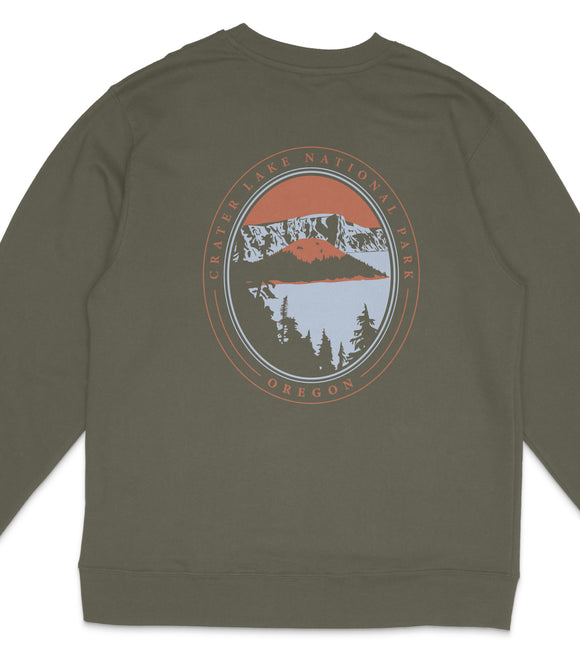 A gray sweatshirt with a graphic design featuring a mountain landscape and the text "Crater Lake National Park Oregon" printed on it.