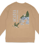 a beige sweater with a graphic design depicting a bird in flight, a castle, and a mountain landscape.