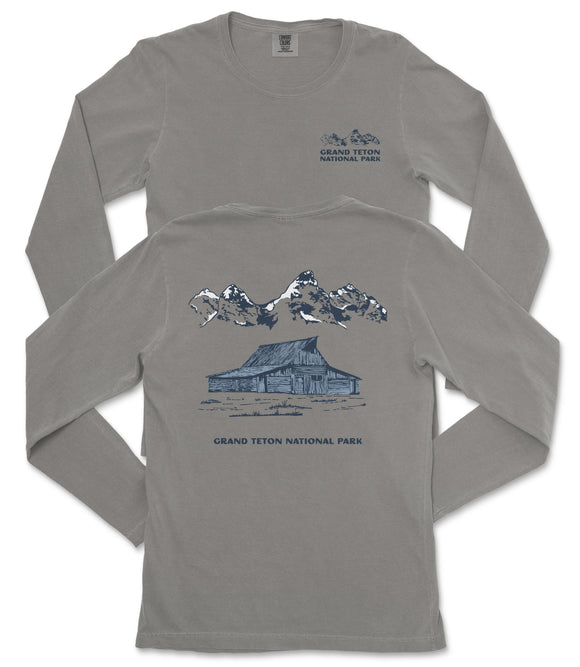 a gray long-sleeved t-shirt with a graphic design depicting a cabin and mountains, along with the text "Grand Teton National Park".