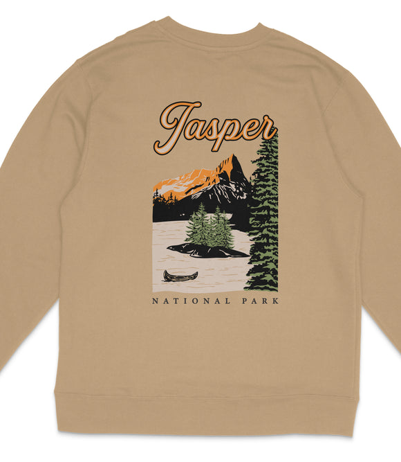 A beige sweatshirt with a graphic design depicting a scenic landscape with mountains, pine trees, and a canoe on a lake.