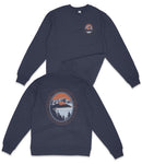 a navy blue long-sleeved shirt with a graphic design on the back. The design includes a circular emblem with a mountain landscape and a sunset, along with the text "Caterina Lake Nature Preserve Oregon".