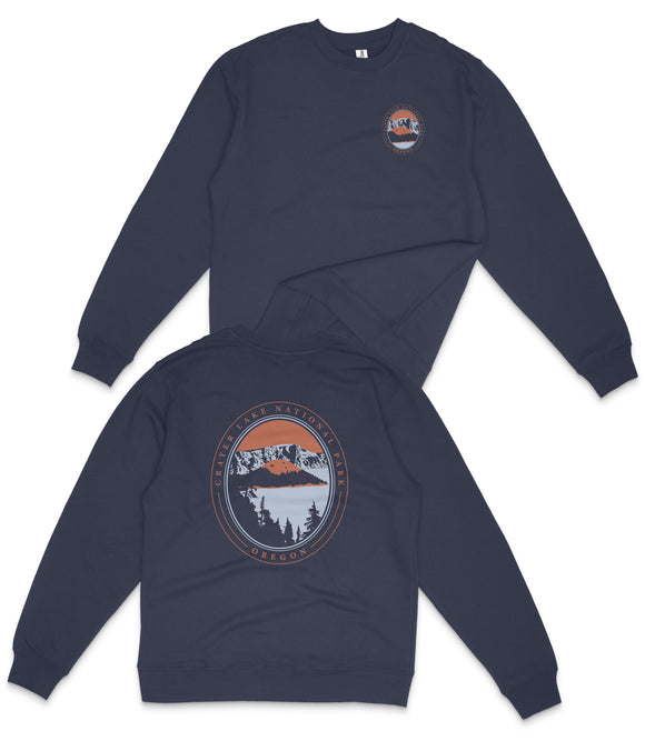 a navy blue long-sleeved shirt with a graphic design on the back. The design includes a circular emblem with a mountain landscape and a sunset, along with the text "Caterina Lake Nature Preserve Oregon".