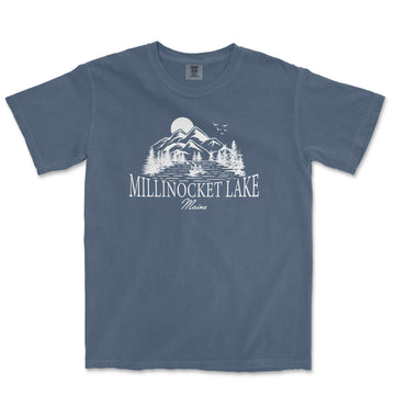 a blue t - shirt with a lake and mountains in the background