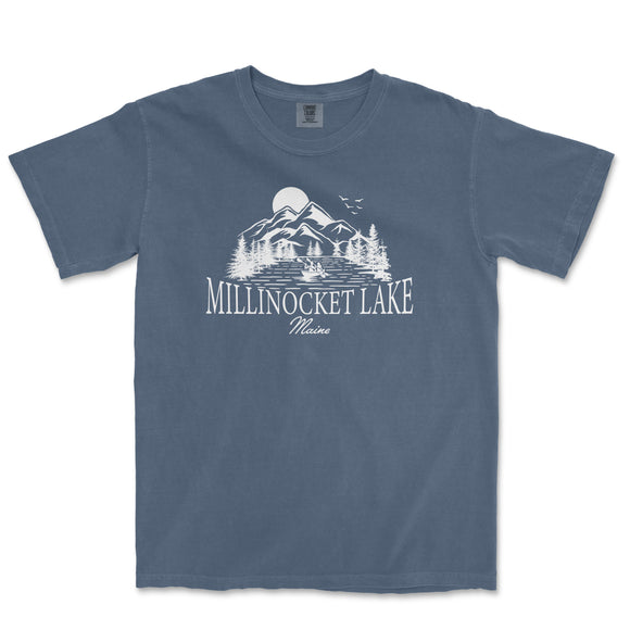 a blue t - shirt with a lake and mountains in the background