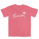 a pink t - shirt with a palm tree and the word bernda in white