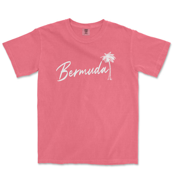 a pink t - shirt with a palm tree and the word bernda in white