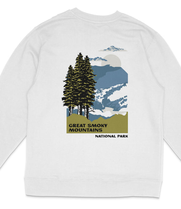 A white long-sleeved shirt with a graphic design depicting a forest scene with pine trees, mountains, and a cloudy sky.