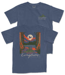 A blue t-shirt with a graphic design depicting a sunset over a lake, with a bird flying over the water. The text "EVERGLADES NATIONAL PARK" is printed on the back of the shirt.