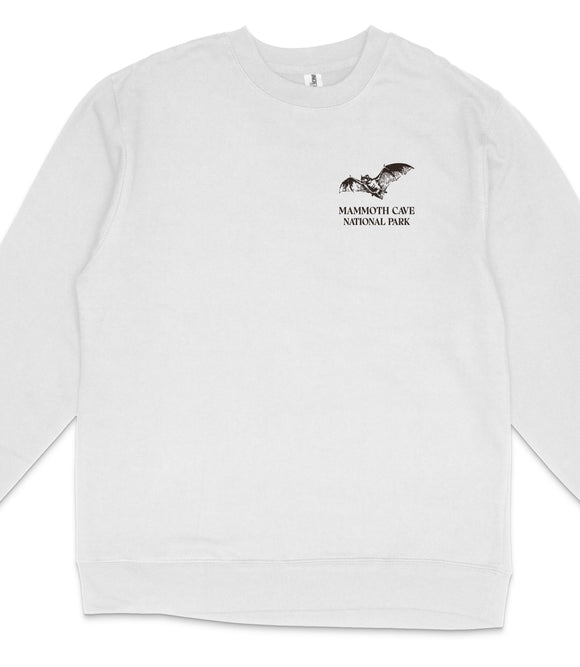 A white long-sleeved shirt with a black graphic design on the left side, depicting a bat and the text "Mammoth Cave National Park".