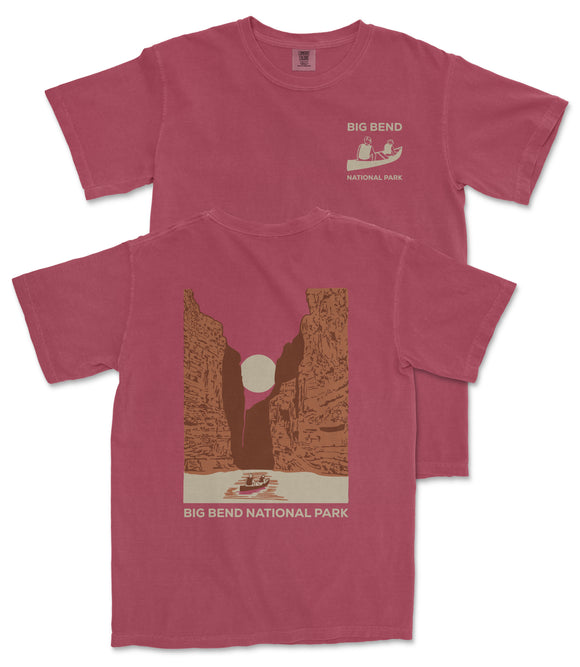 A red t-shirt with a graphic design depicting a canyon landscape and a boat on a river, along with the text "BIG BEND NATIONAL PARK".