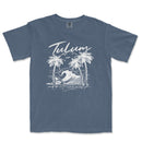 a blue t - shirt with a picture of a wave and palm trees