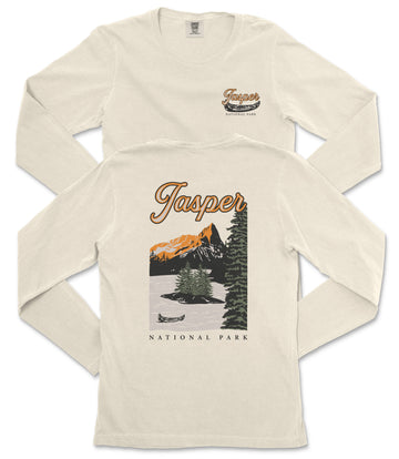 A cream-colored long-sleeved t-shirt with a graphic design depicting a scenic landscape with mountains, trees, and a lake, along with the text "Jasper National Park" printed on the back.