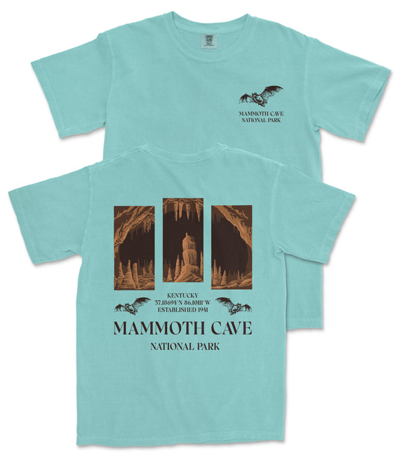 A light blue t-shirt with a graphic design depicting a cave and bats, along with text that reads "Mammoth Cave National Park" and "Kentucky cave system".