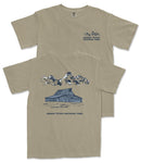A beige t-shirt with a graphic design depicting a cabin and mountains, along with the text "Grand Teton National Park" printed on the back.