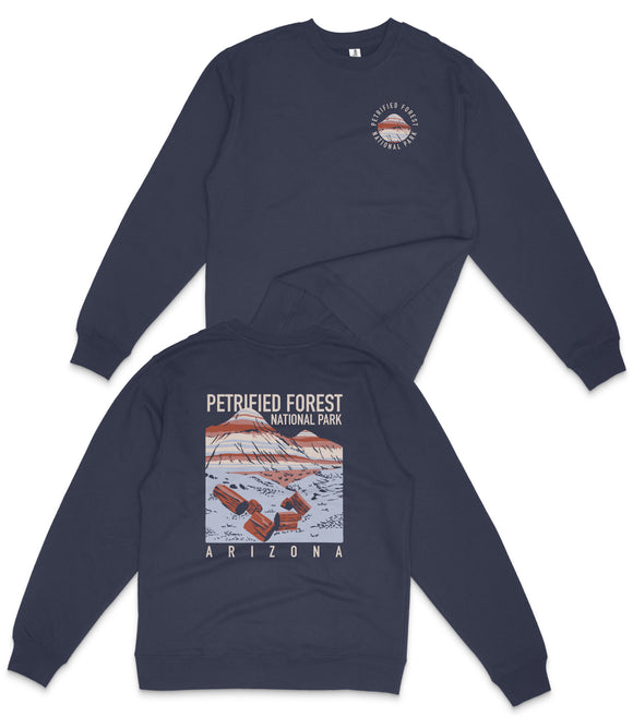 A navy blue sweatshirt with a graphic design depicting a desert landscape and the text "PETRIFIED FOREST NATIONAL PARK ARIZONA" printed on the back.