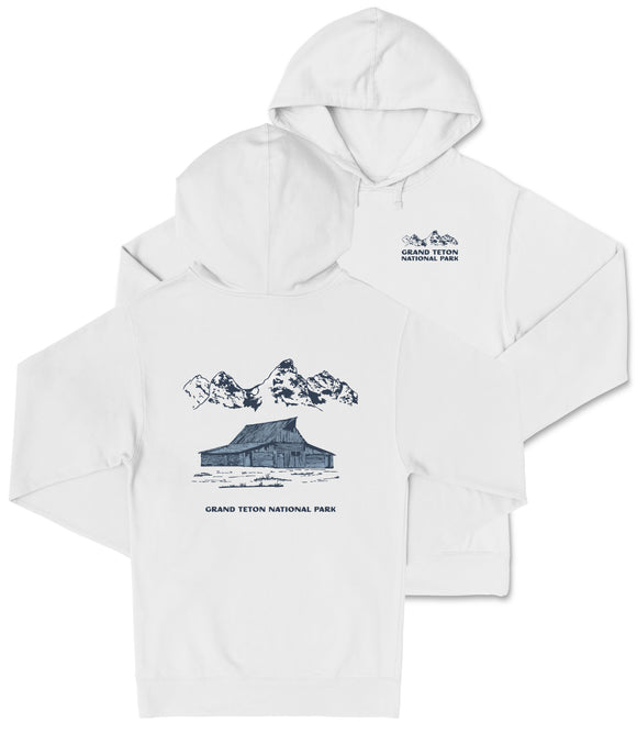 A white hooded sweatshirt with a graphic design depicting a cabin and mountains, along with text that reads "Grand Teton National Park".
