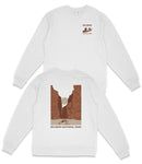 A white long-sleeved shirt with a graphic design depicting a canyon or rock formation, along with text that reads "BIG BEND NATIONAL PARK".